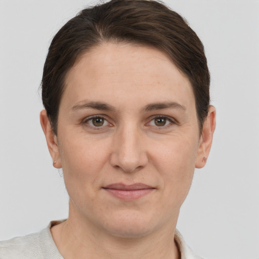 Joyful white adult female with short  brown hair and grey eyes