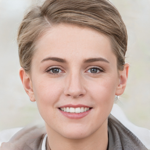 Joyful white young-adult female with medium  brown hair and blue eyes