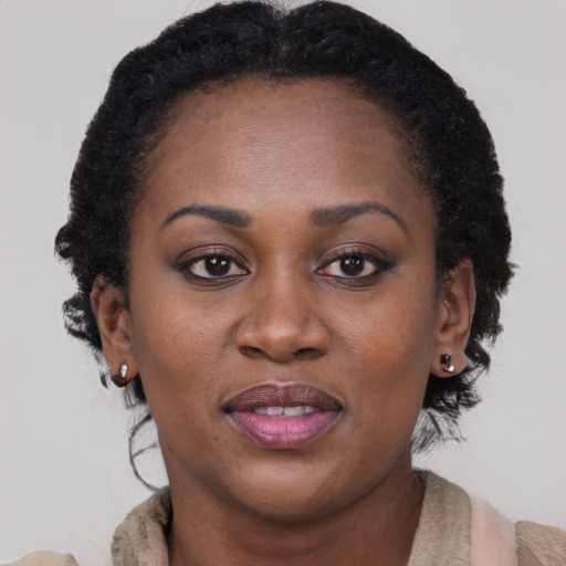 Joyful black adult female with medium  brown hair and brown eyes