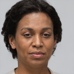 Joyful black adult female with short  brown hair and brown eyes