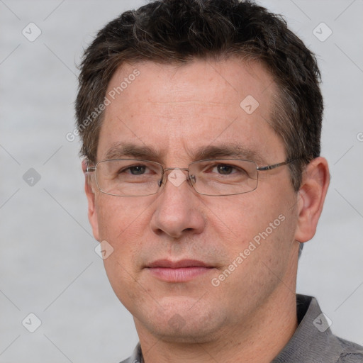 Joyful white adult male with short  brown hair and grey eyes