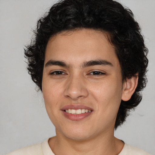 Joyful latino young-adult male with medium  brown hair and brown eyes