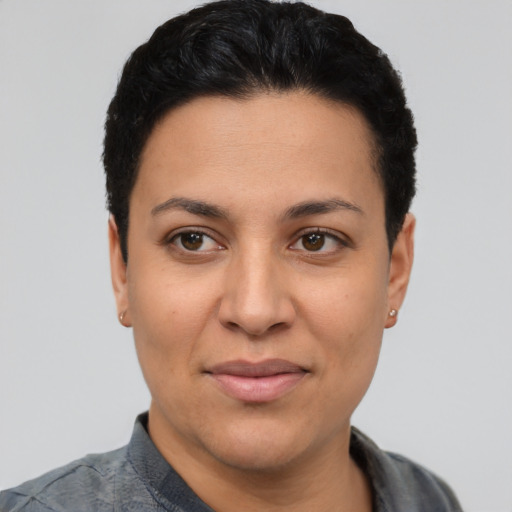 Joyful latino adult female with short  black hair and brown eyes