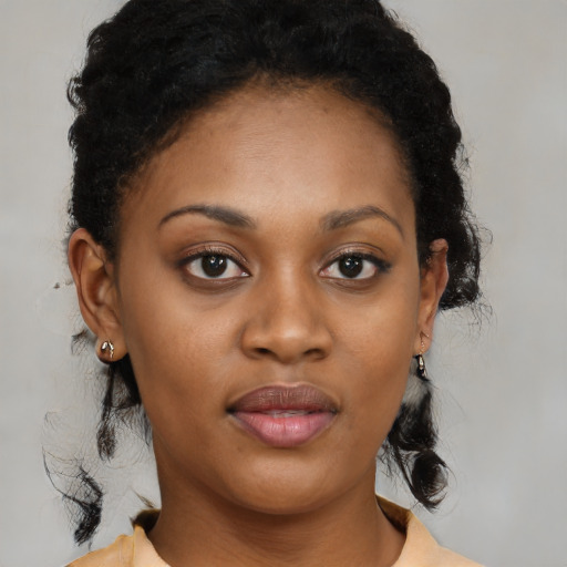 Joyful black young-adult female with medium  black hair and brown eyes