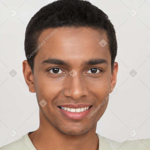 Joyful black young-adult male with short  brown hair and brown eyes