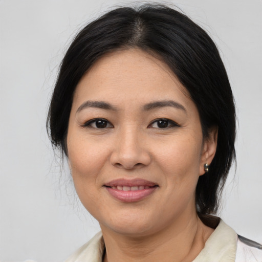 Joyful asian young-adult female with medium  black hair and brown eyes