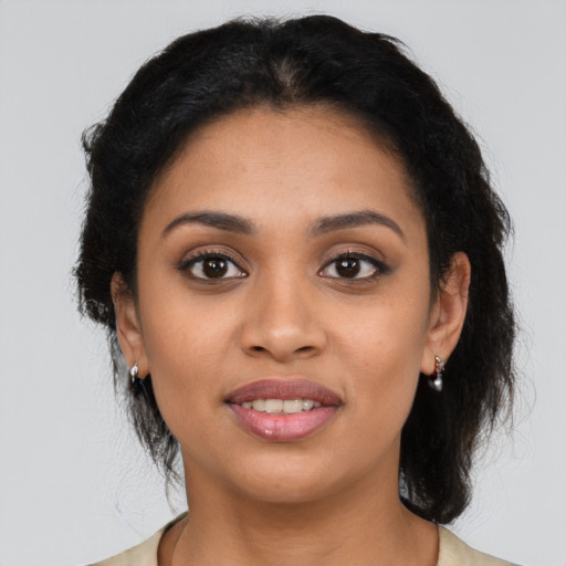 Joyful latino young-adult female with long  black hair and brown eyes
