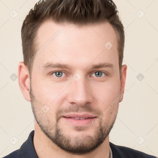 Joyful white young-adult male with short  brown hair and grey eyes