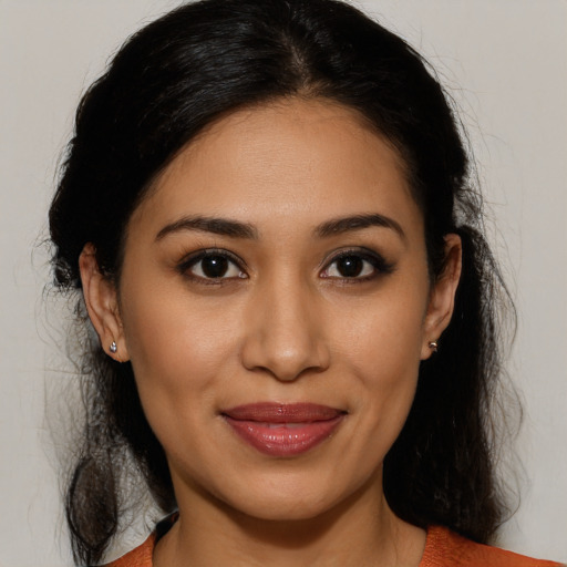 Joyful latino young-adult female with long  brown hair and brown eyes