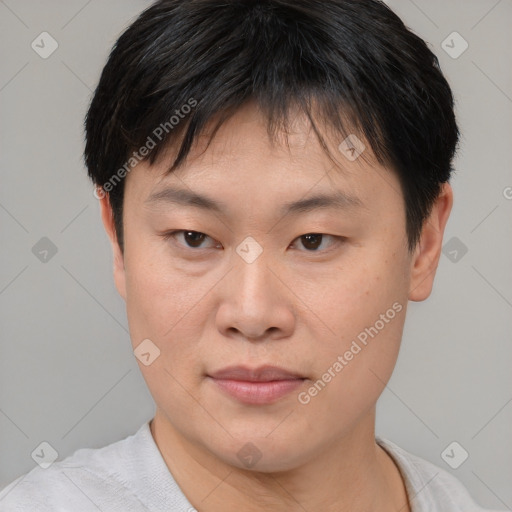 Joyful asian young-adult male with short  brown hair and brown eyes