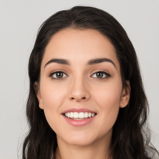 Joyful white young-adult female with long  black hair and brown eyes