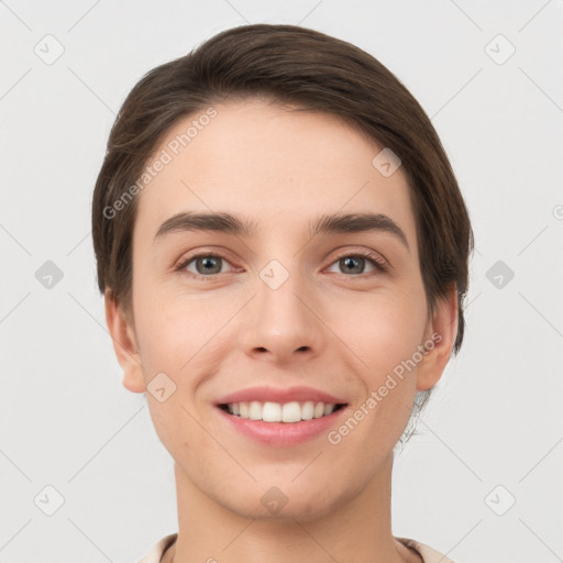 Joyful white young-adult female with short  brown hair and grey eyes