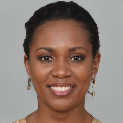 Joyful black young-adult female with short  black hair and brown eyes