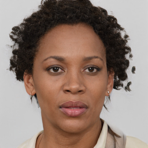 Joyful black adult female with short  brown hair and brown eyes