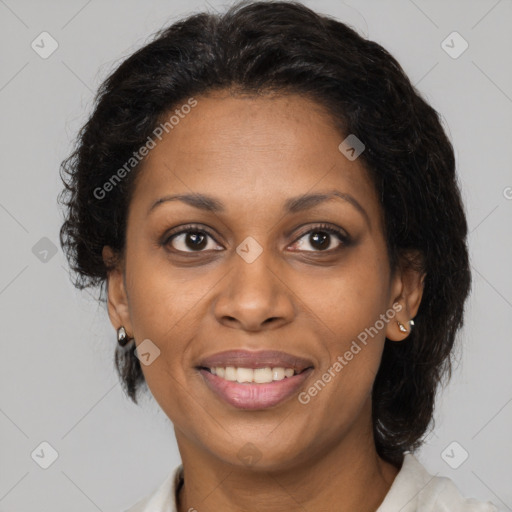 Joyful black adult female with medium  brown hair and brown eyes