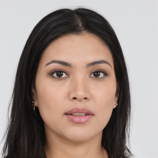 Joyful asian young-adult female with long  brown hair and brown eyes