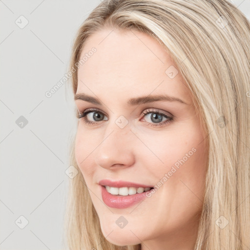 Joyful white young-adult female with long  brown hair and blue eyes