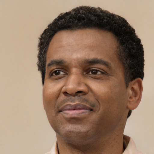Joyful latino adult male with short  black hair and brown eyes