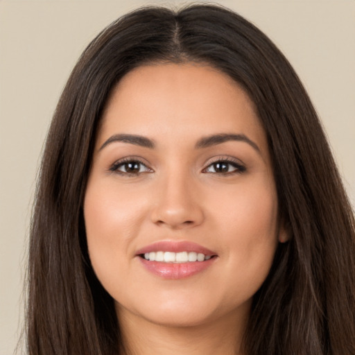 Joyful white young-adult female with long  brown hair and brown eyes