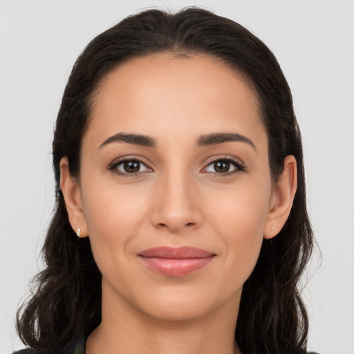 Joyful latino young-adult female with long  brown hair and brown eyes