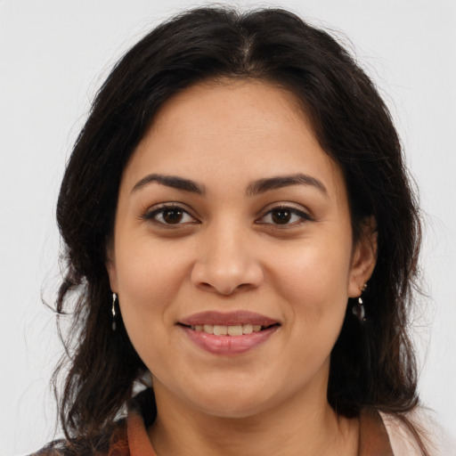 Joyful latino young-adult female with medium  brown hair and brown eyes