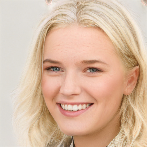 Joyful white young-adult female with long  brown hair and blue eyes