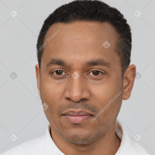 Joyful latino adult male with short  black hair and brown eyes