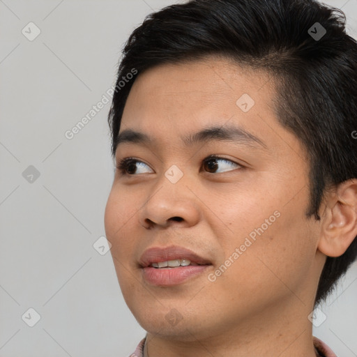 Joyful asian young-adult male with short  brown hair and brown eyes