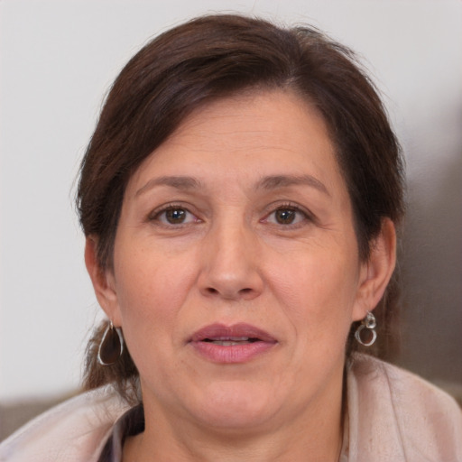 Joyful white adult female with medium  brown hair and brown eyes