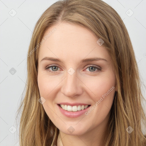 Joyful white young-adult female with long  brown hair and grey eyes