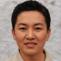 Joyful asian young-adult male with short  black hair and brown eyes