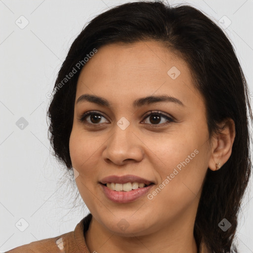 Joyful latino young-adult female with medium  brown hair and brown eyes