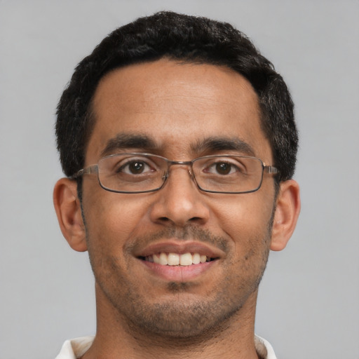 Joyful latino adult male with short  black hair and brown eyes