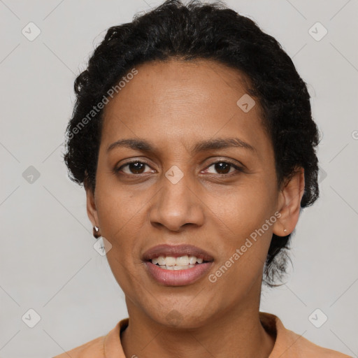 Joyful black adult female with short  black hair and brown eyes