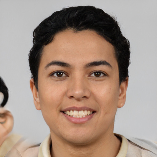 Joyful latino young-adult male with short  black hair and brown eyes