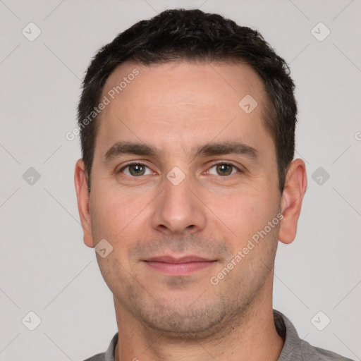 Joyful white young-adult male with short  black hair and brown eyes