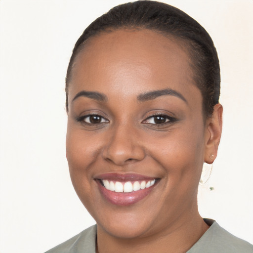 Joyful black young-adult female with short  brown hair and brown eyes