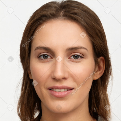 Joyful white young-adult female with long  brown hair and grey eyes