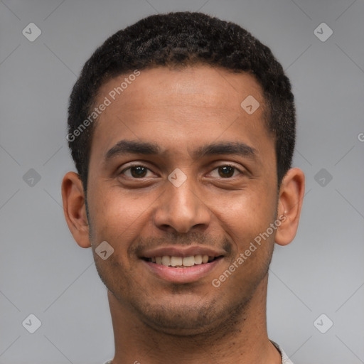 Joyful black young-adult male with short  brown hair and brown eyes