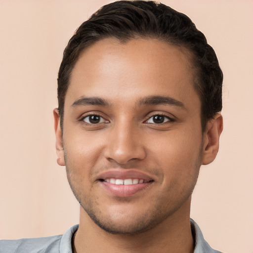 Joyful white young-adult male with short  black hair and brown eyes