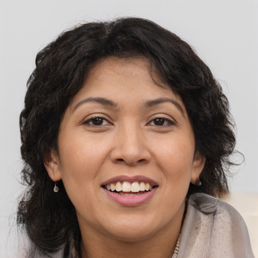 Joyful latino young-adult female with long  brown hair and brown eyes