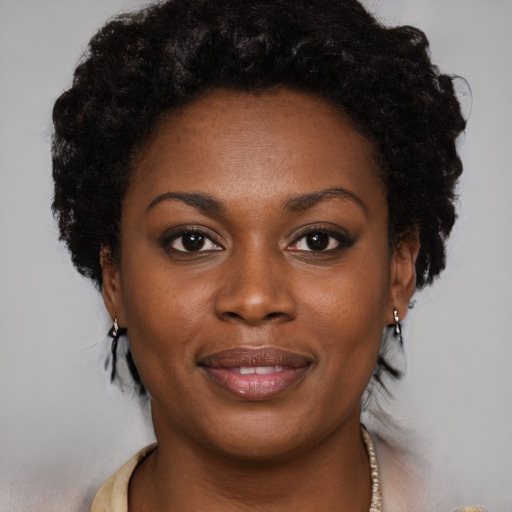 Joyful black young-adult female with long  brown hair and brown eyes