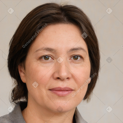 Joyful white adult female with medium  brown hair and grey eyes