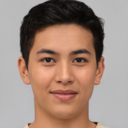 Joyful asian young-adult male with short  brown hair and brown eyes