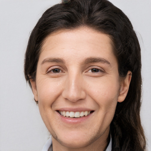 Joyful white adult female with long  brown hair and brown eyes