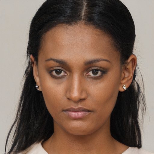 Neutral black young-adult female with long  brown hair and brown eyes