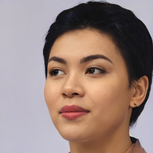 Joyful asian young-adult female with short  black hair and brown eyes