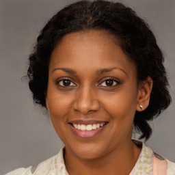 Joyful black young-adult female with medium  brown hair and brown eyes