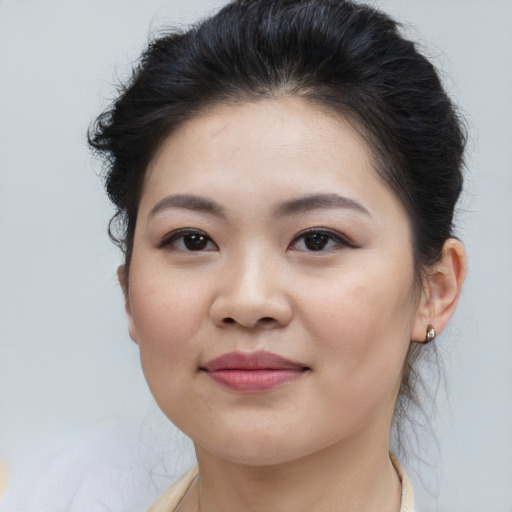 Joyful asian young-adult female with medium  brown hair and brown eyes