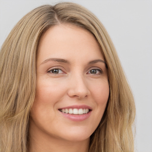 Joyful white young-adult female with long  brown hair and green eyes